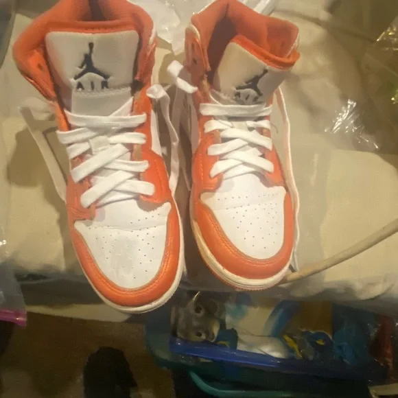 Nike mid 1 orange and white air Jordan.